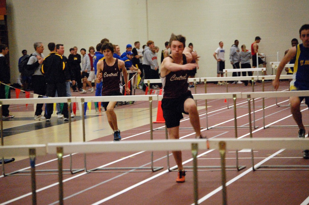 Central sophomore Kyle Mobile, Bristol, (left) and Jason Castona, a freshman from Bristol compete in a 60-yard hurdles heat.