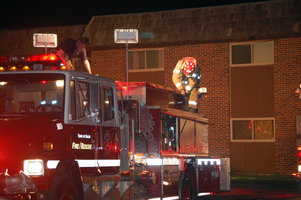 Firefighters secure equipment at the scene of a excessive smoke call Friday evening.