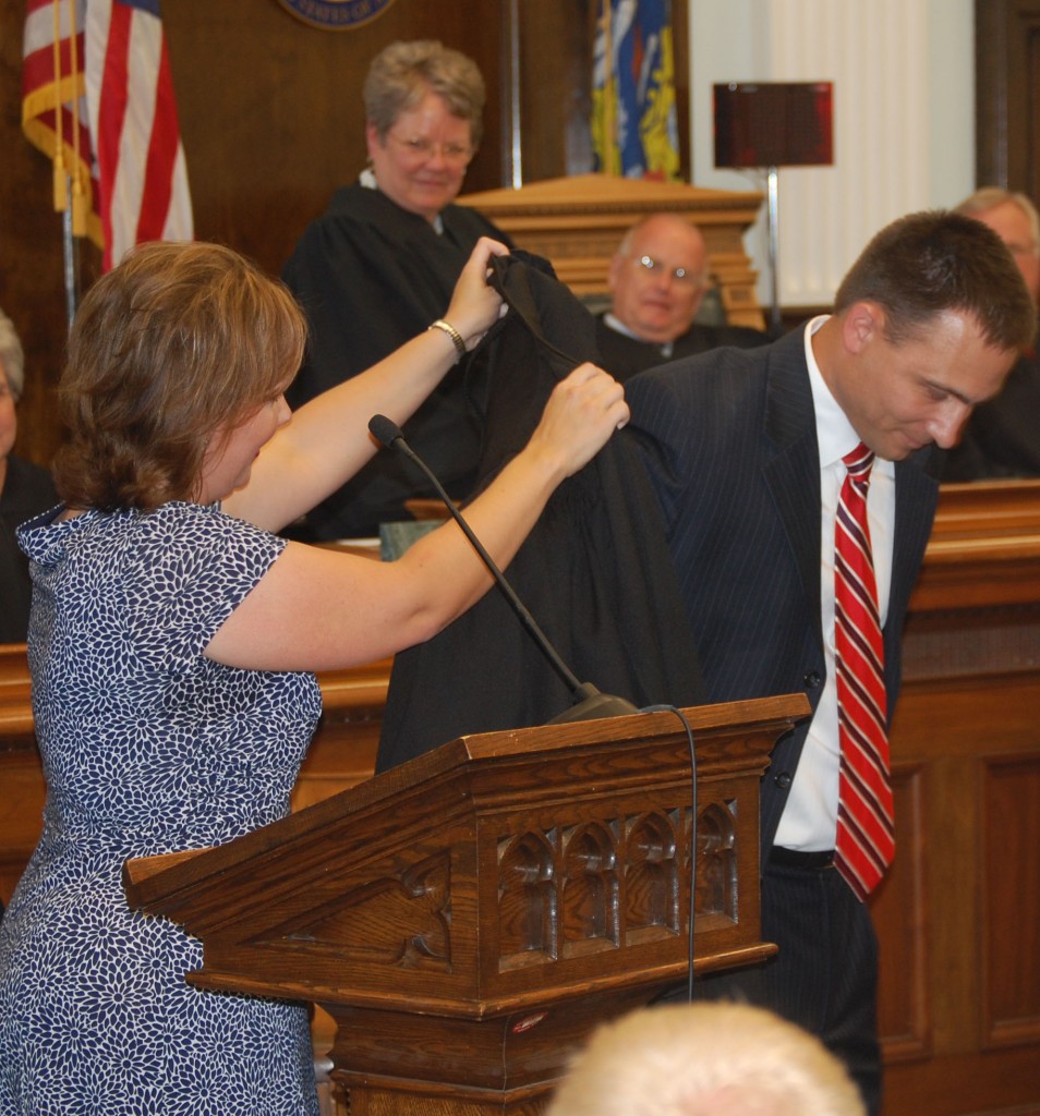 Chad Kerkman is helped into his judicial robe by his wife, state Rep. Samantha Kerkman.