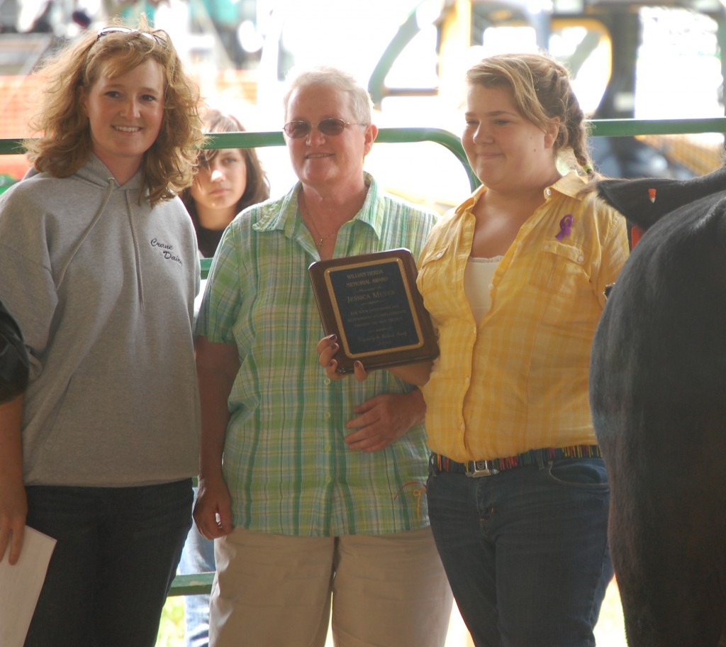 Rachel Crane (left) and Patti Herda present the William Herda Memorial Award to Jessica Meyer.