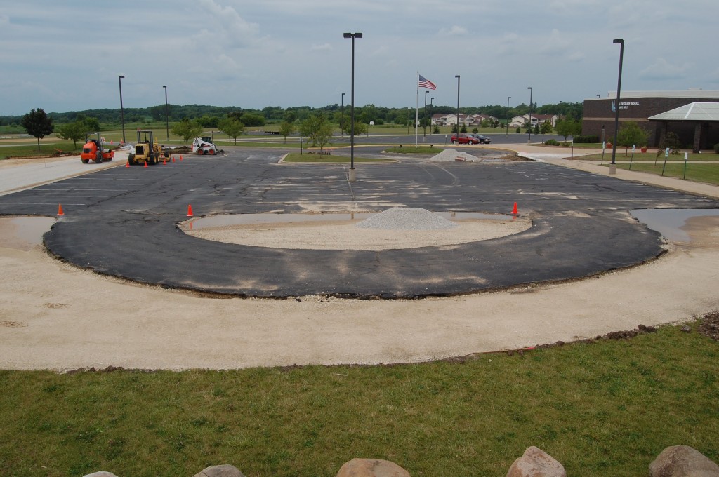 This photo shows the visitor parking lot at Salem School under construction. The area to the right where there are signs for vistor and disabled parking will become a student drop-off area. The lot is being extended to the left of this photo to compensate for the lost spots and add more parking.
