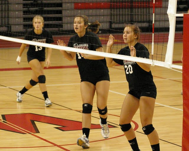 Lauren Hickson, Linda Flahive and Shelby Shumaker get ready to block a Wilmot attack.