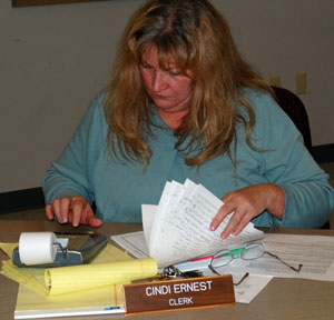 Salem Town Clerk Cindi Ernest recounts the number of electors signed in to vote Tuesday night.