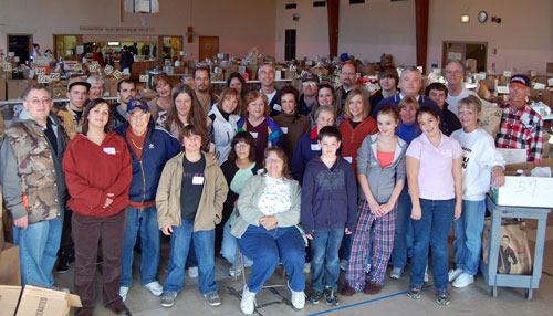The volunteers that worked The Sharing Center's Thanksgiving meal distribution pause to pose for a group photo.