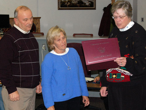 Central High School Board President Mary Ellen Pearsall  (right) reads a certificate award to Paul and Pat Brings fro their work in securing a $35,000 grant for the school's tennis facility.