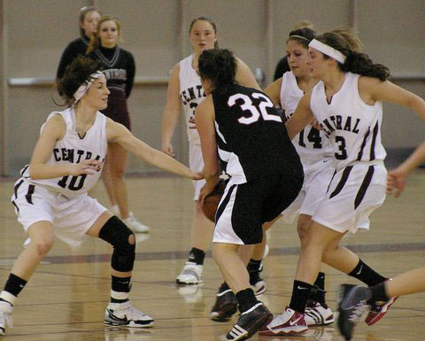 Central's Abbey Reeves, 10, Cassie Cox, 14 and Hayden Krueger collapse on Wilmot's Jackie Herman.