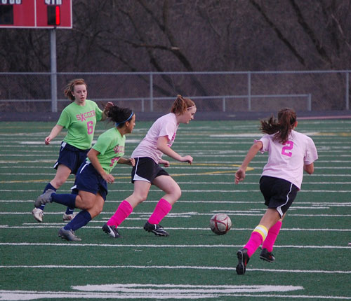 Wilmot's Kristen Weiler and Lauren Romani -- sporting pink uniform shirts -- bring the ball up the field versus Racine park Thursday evening.
