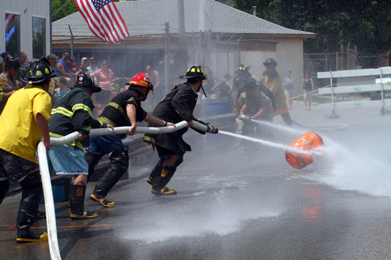 A Trevor team battles a Silver Lake team in the firefighters water fights on Saturday. /Earlene Frederick photo
