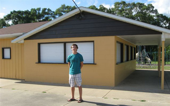 Gerald Ehr in front of the building at New Munster Park for which he organized a re-painting. /Submitted photo