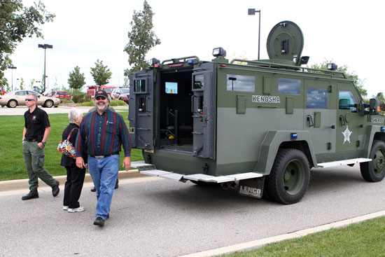 County Supervisor Mike Underhill, of Paddock Lake, gets a look at the Sheriff's Department armored vehicle. /Earlene Frederick photo