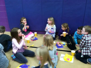 First grade students spend time after the ceremony to talk and eat. /Submitted photo