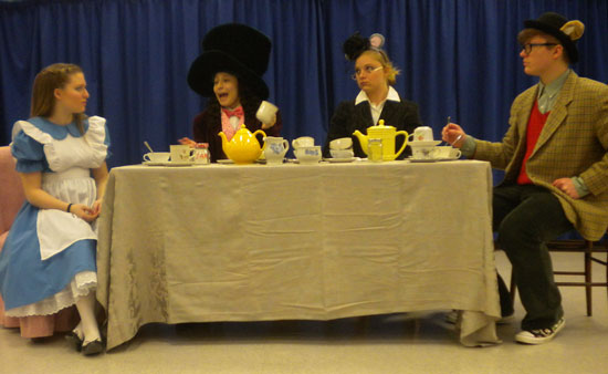 The Mad Hatter poses yet another riddle to Alice as the Dormouse and March Hare listen intently.  Left to right: Hannah Kunce, Raquel Rivas, Destiny Kent and Kyle Racas.  /Submitted photo