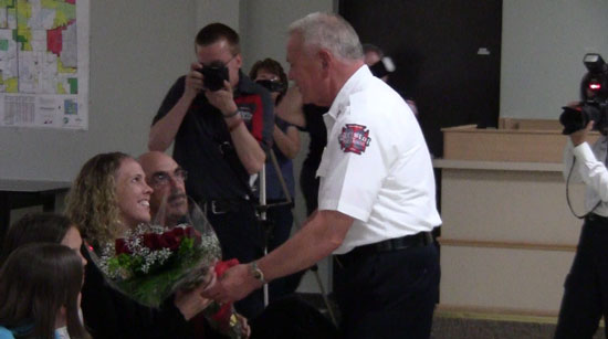 Bristol Fire and Rescue Chief Peter Parker presents flower to Christine Borggren.