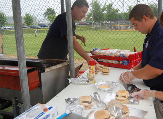 Bristol village administrator and fire department member  Randy Kerkman takes some burgers off the grill at the Bristol Fire Department burgers booth.