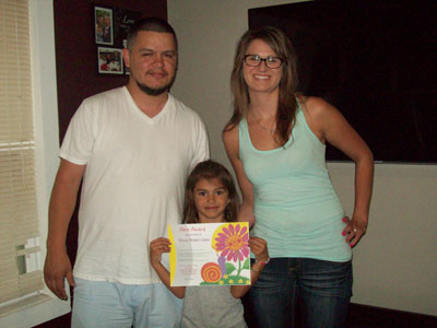 Olivia (center) with her parents Luis & Liane. /Contributed photo