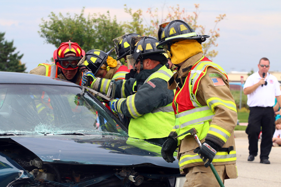 Firefighters demonstrate how they cut a car apart as Somers Fire Chief Tom Smith explains what they are doing. 