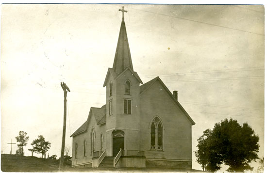 This image is from 1908 and is of Holy Name of Jesus church immediately north of the Cemetery on the hill at Hwy C and B n Wilmot. The clapboard building burned in 1913 presumably started by lightning strike.​ It was west of the path near the top of the hill to the cemetery.​ /Contributed photo, used with permission of Western Kenosha County Historical Society