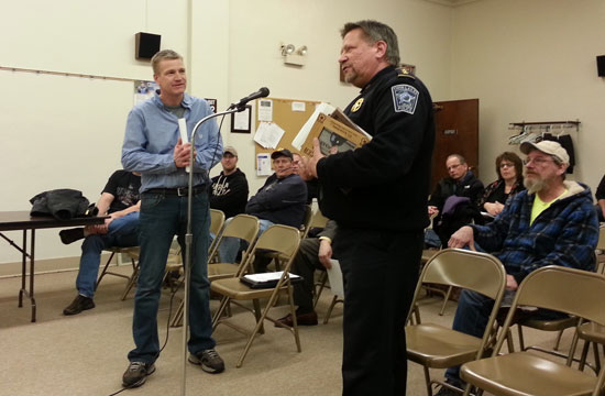 Twin Lakes Police Chief Dale Racer (right) presents Kevin Klahs, retired TLPD officer, with a plaque of appreciation at Monday's Village Board meeting.