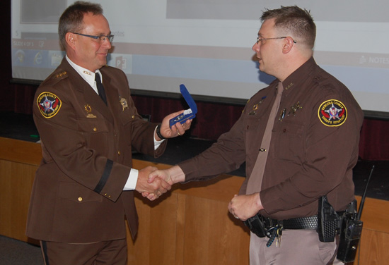 Sheriff David Beth presents Deputy John Wilke with his second Silver Star. 