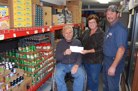 (From left) Ozinga's Denny Ketterhagen, Melissa Papacek from the Twin Lakes Food Pantry and Twin Lakes village President Howard Skinner.