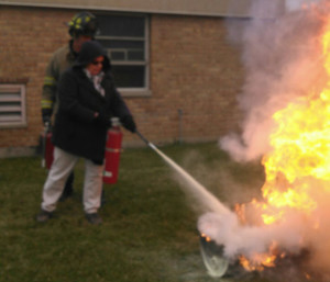 Village Clerk Emily Uhlenhake puts out a fire. /Submitted photo