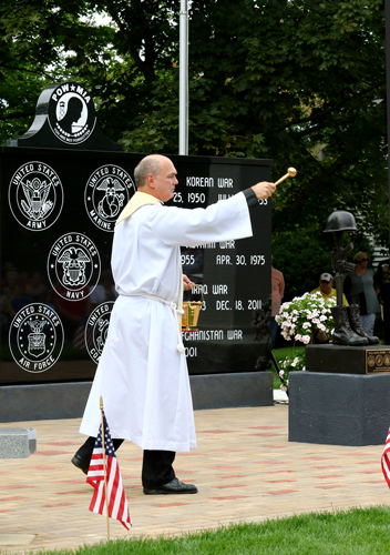 Fr. Russell Arnett blessing the monument.